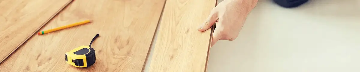 A professional installing wood flooring in Detroit, MI