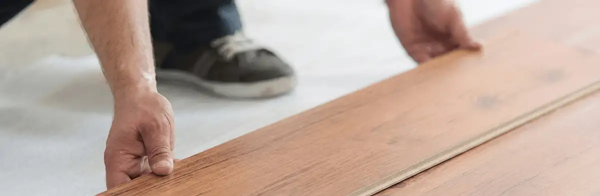 A professional installing laminate flooring in Detroit, MI