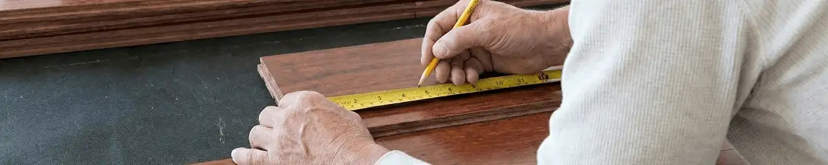 A professional installing wood flooring in Detroit, MI
